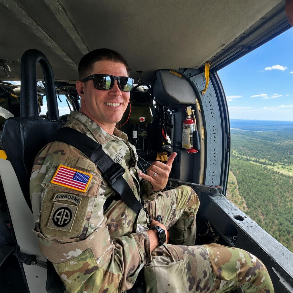 Phil serving in the United States Army aboard a helicopter